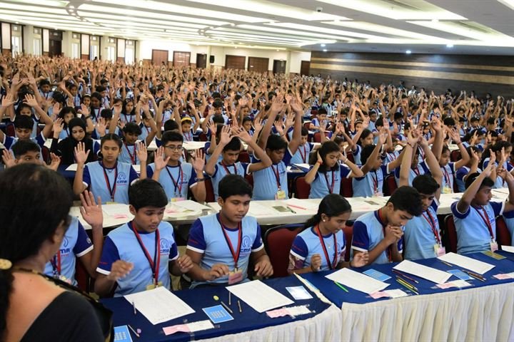 Hundreds of CMA students raising their hands during a national assessment