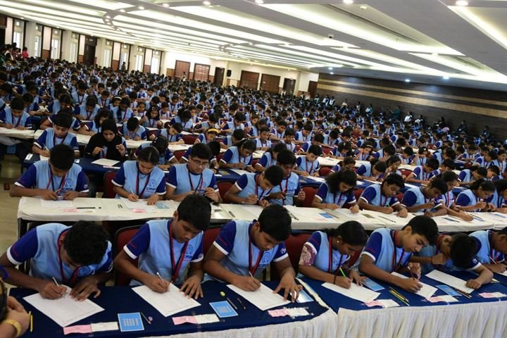 CMA students in their CMA uniforms concentrating on an assessment