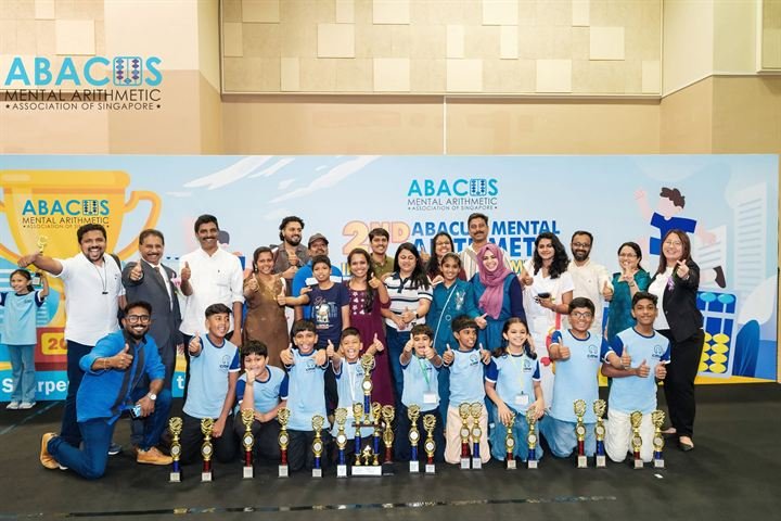CMA students and parents giving thumbs up with their trophies